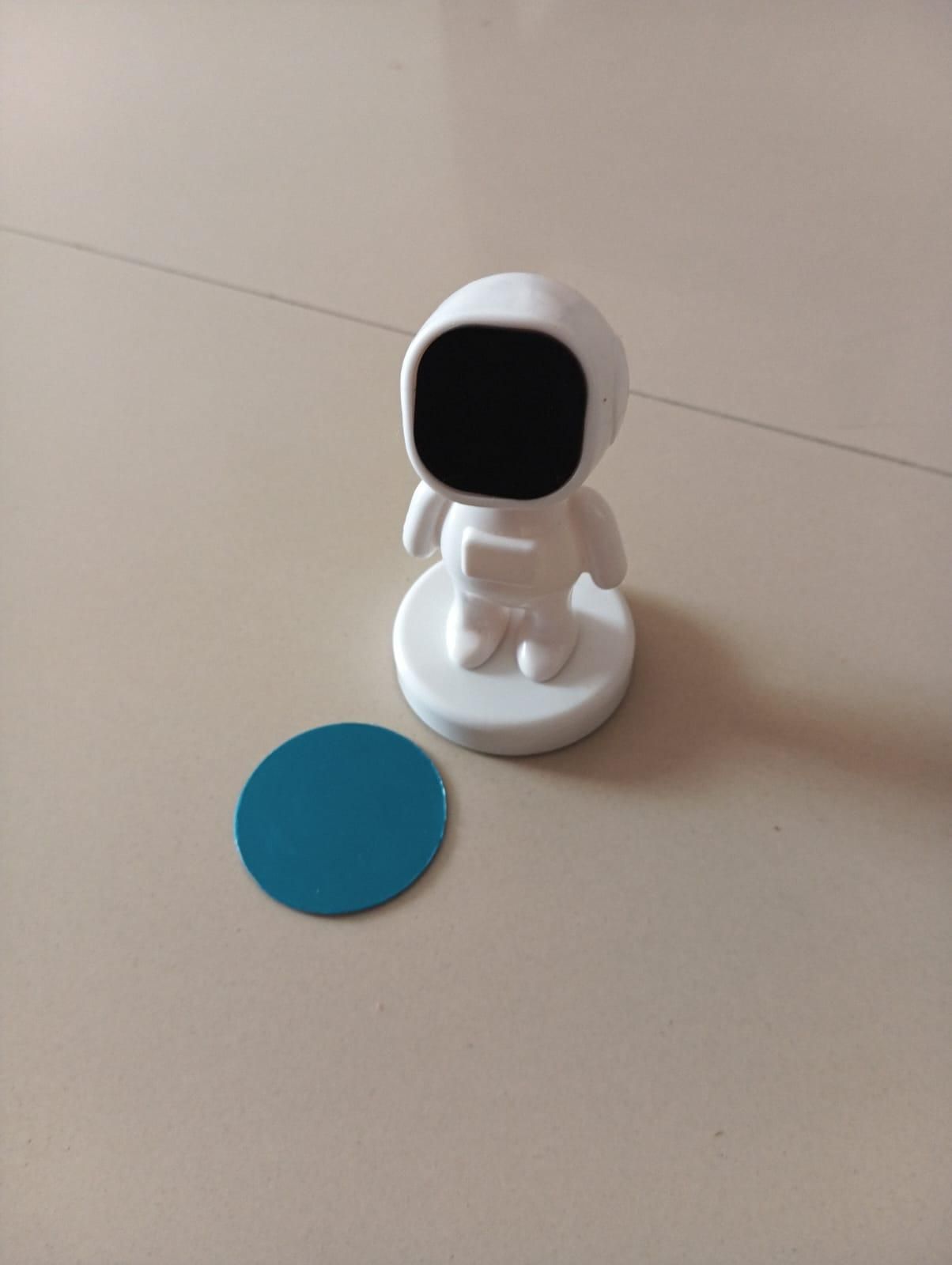 Livingdot magnetic car phone holder in astronaut design with metal plate on beige surface