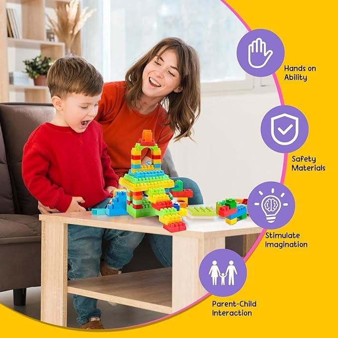 Child and woman playing with colorful children's building block set on wooden table indoors