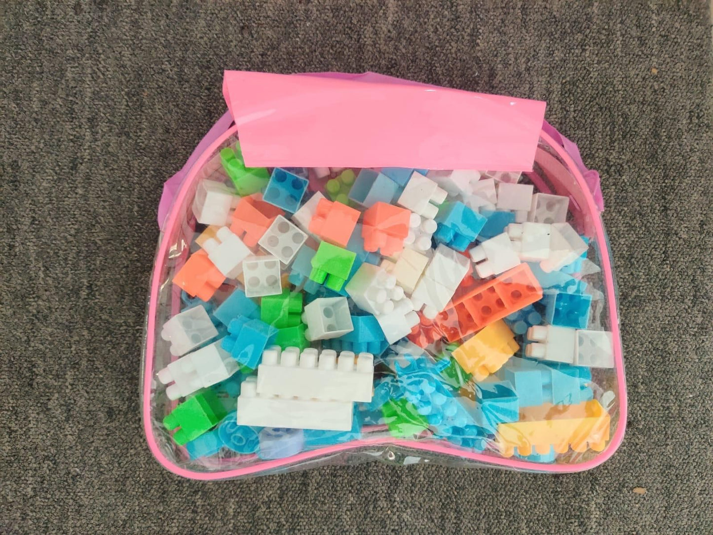 Livingdot children's building block set with colorful plastic bricks in a clear pink storage bag