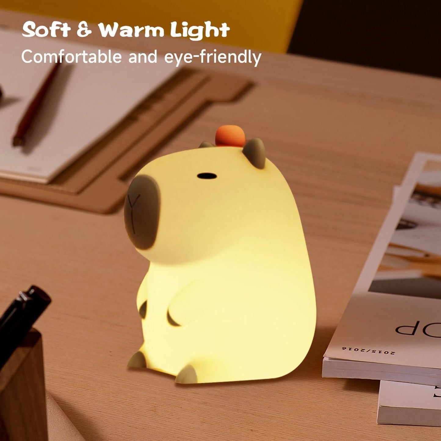 Cute animal-shaped children's night light LED glowing with soft and warm light on wooden desk