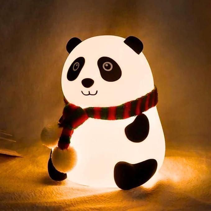 Cute panda night light glowing warmly with a red and green striped scarf in a cozy setting