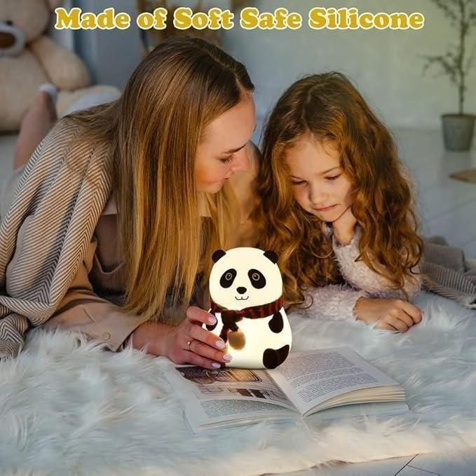 Cute panda night light made of soft safe silicone held by woman reading book with child