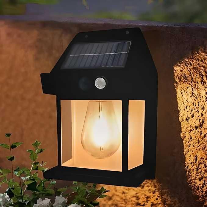 Black solar-powered energy-efficient garden lighting mounted on a wall illuminating outdoor plants