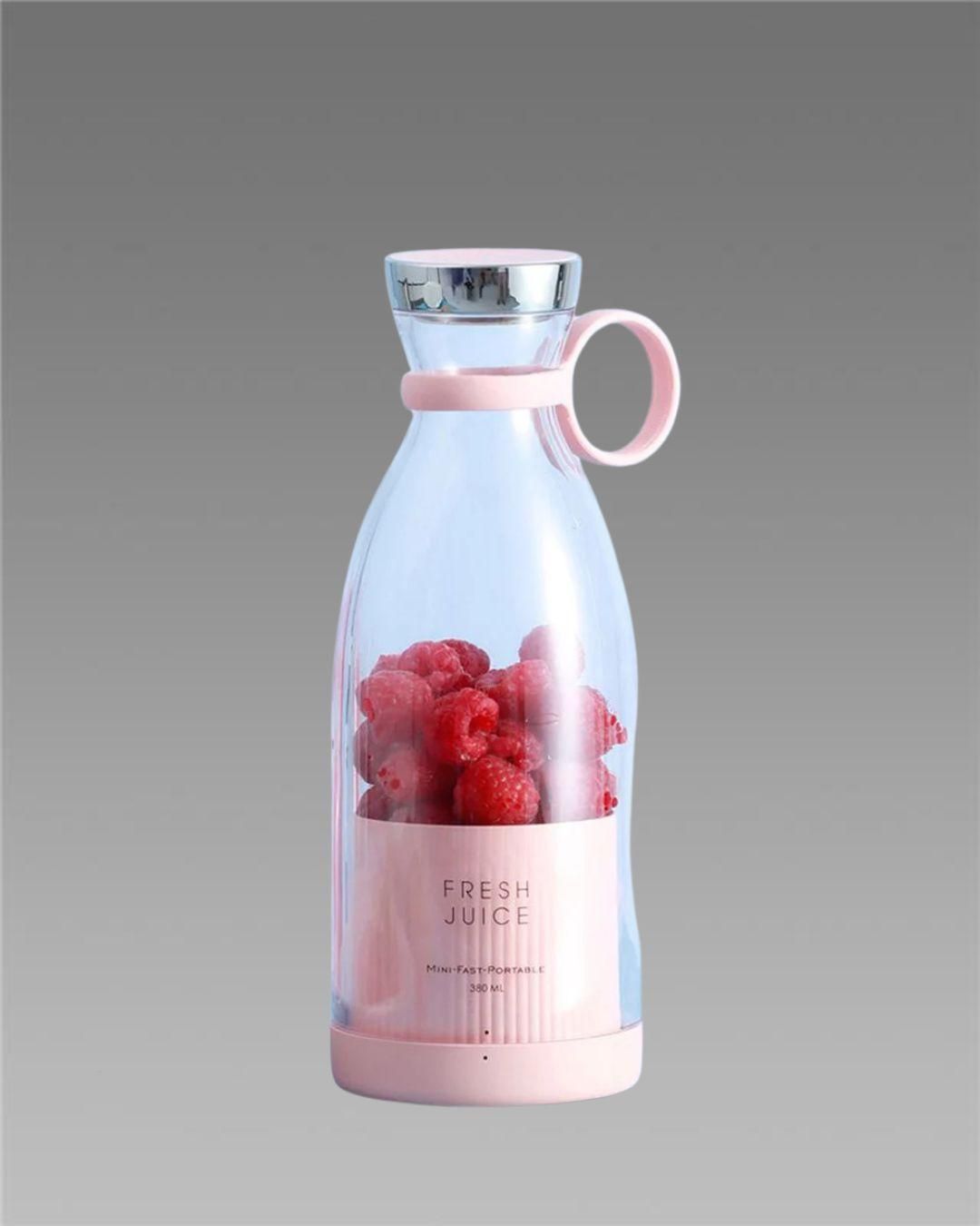 Livingdot portable mini juice blender in pink with fresh raspberries inside and silver lid