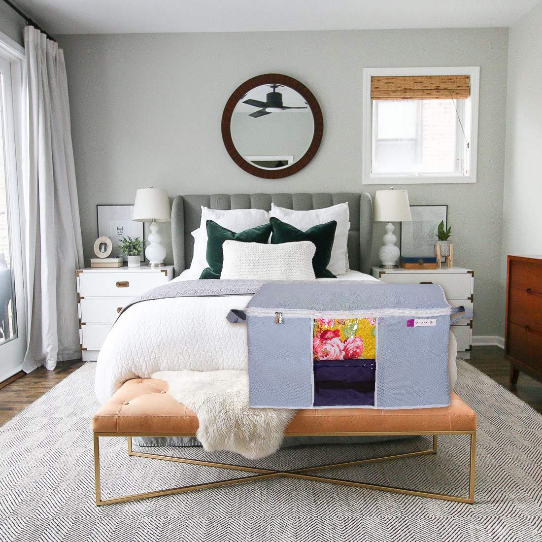 Livingdot gray underbed storage bag with zipper closure holding colorful items in a modern bedroom