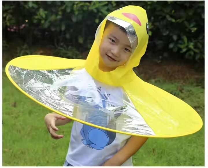 Livingdot kid's duck rain cover in bright yellow with clear face shield worn by child outdoors