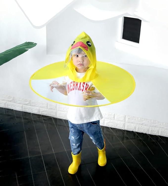 Child wearing a yellow kid's duck rain cover with hood and round waterproof shield indoors