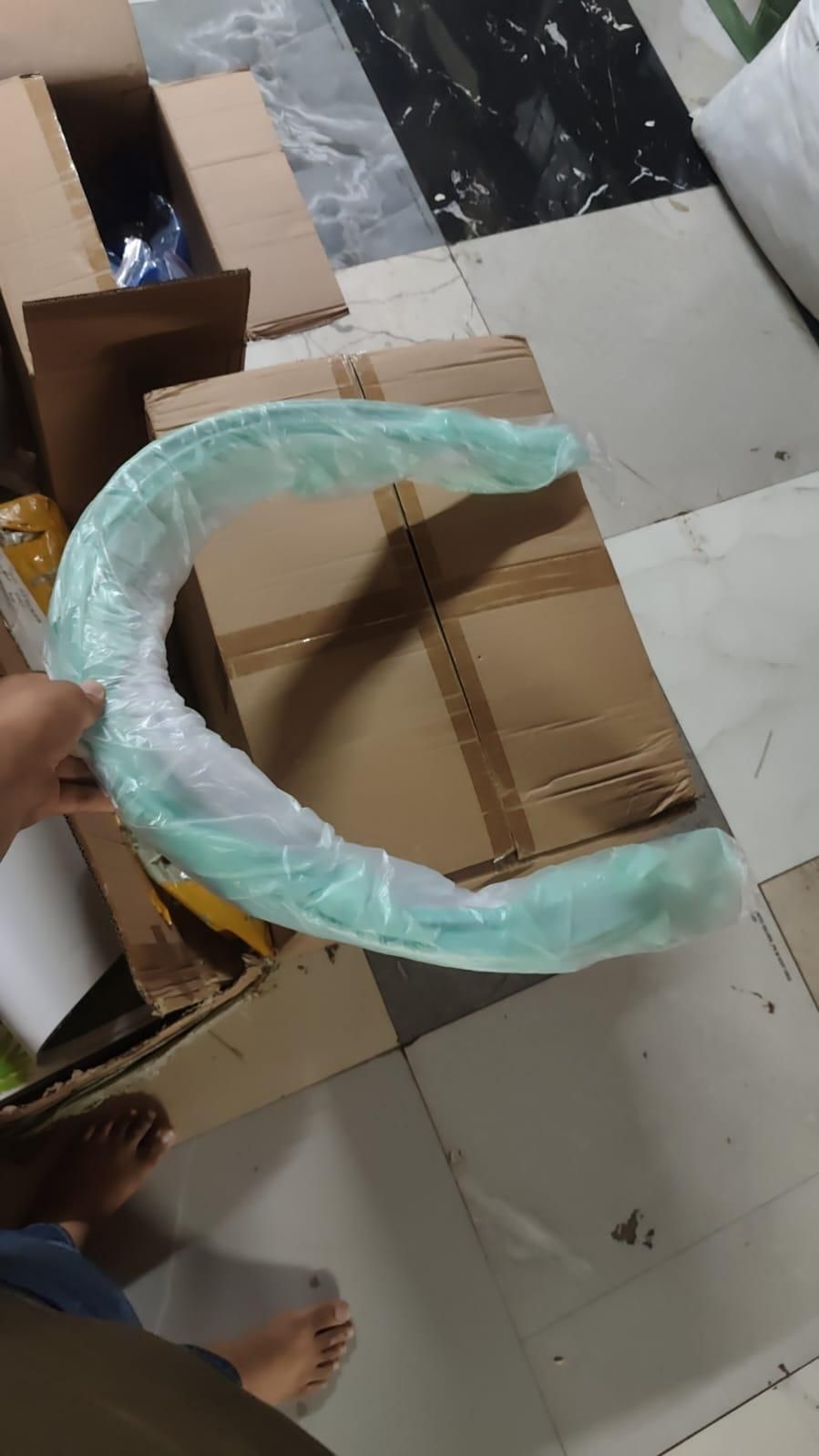 Livingdot best mosquito net for baby in protective packaging being held over cardboard box