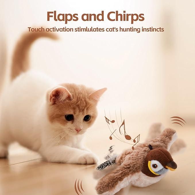 Cute kitten playing with a realistic motion cat toy bird that flaps wings and chirps