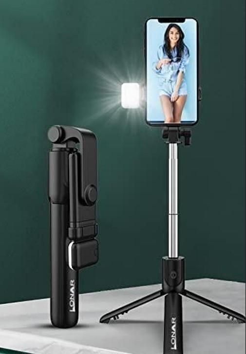 Livingdot portable selfie stick for travel with built-in light and tripod stand holding a smartphone