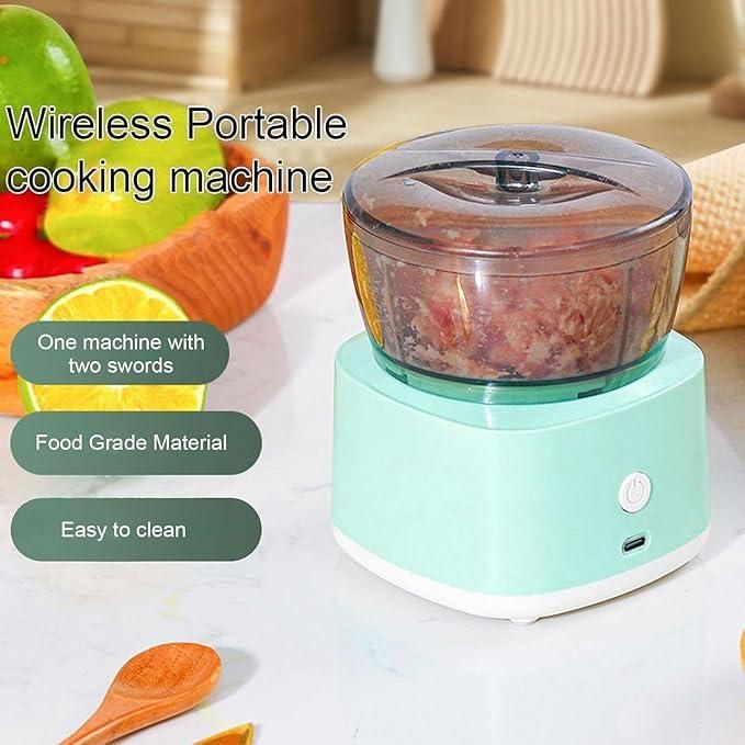 Compact multifunctional food processor in mint green color with transparent lid on kitchen countertop