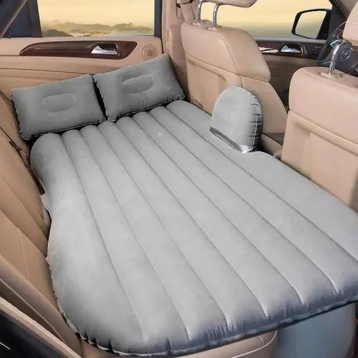 Livingdot gray inflatable portable car travel bed with pillows set up in the backseat of a vehicle