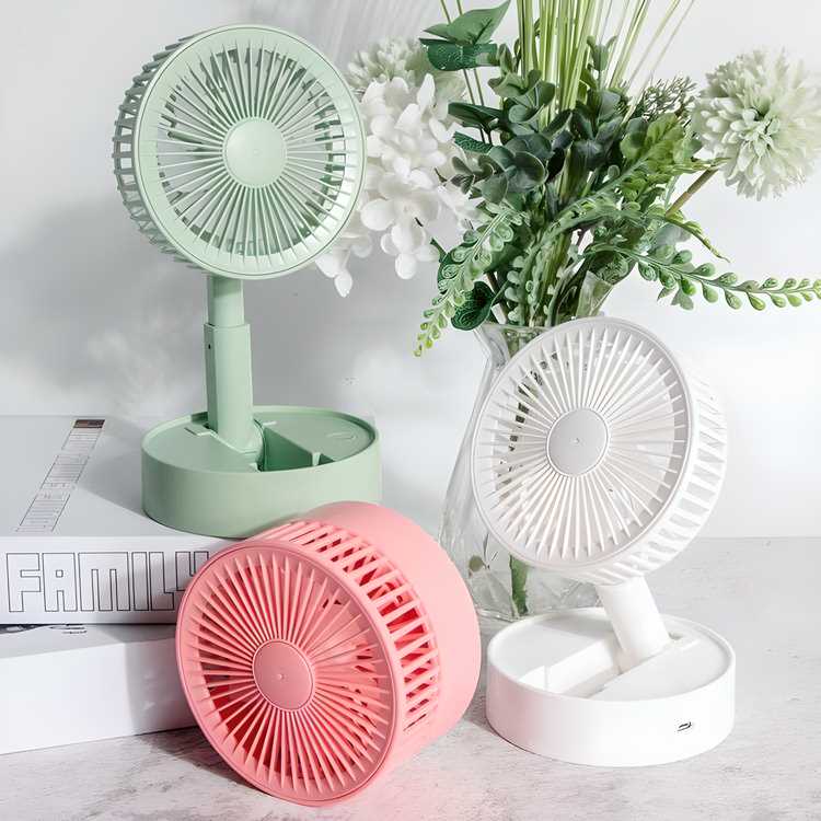 Livingdot portable mini USB fan in green, white, and pink colors displayed on a table with flowers