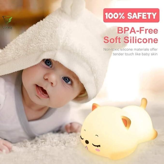 Soft glow cat light for kids made of BPA-free soft silicone next to baby in white hooded towel