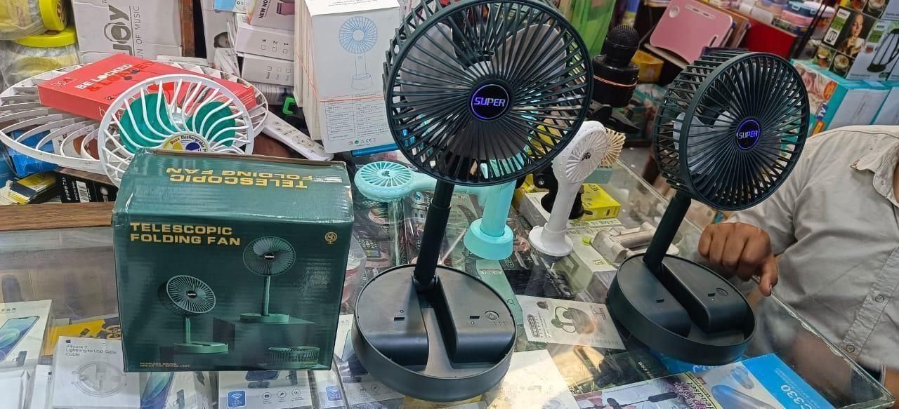 Livingdot adjustable standing fan in black with telescopic folding feature displayed on a glass counter