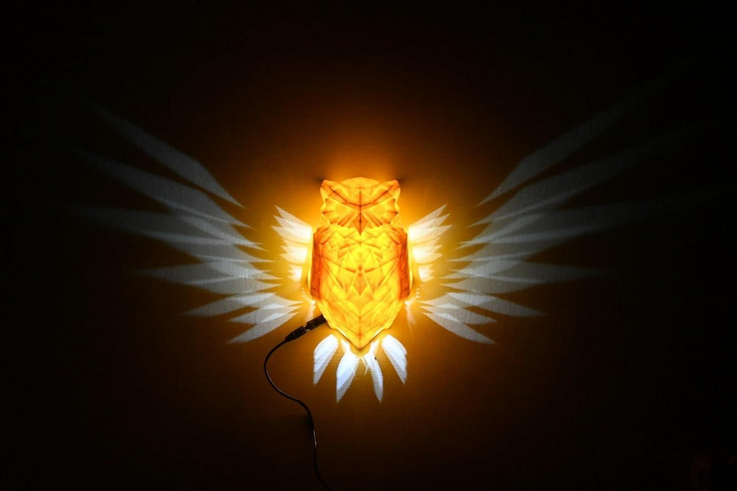 Livingdot unique owl wall light glowing orange with white wings projection on dark wall