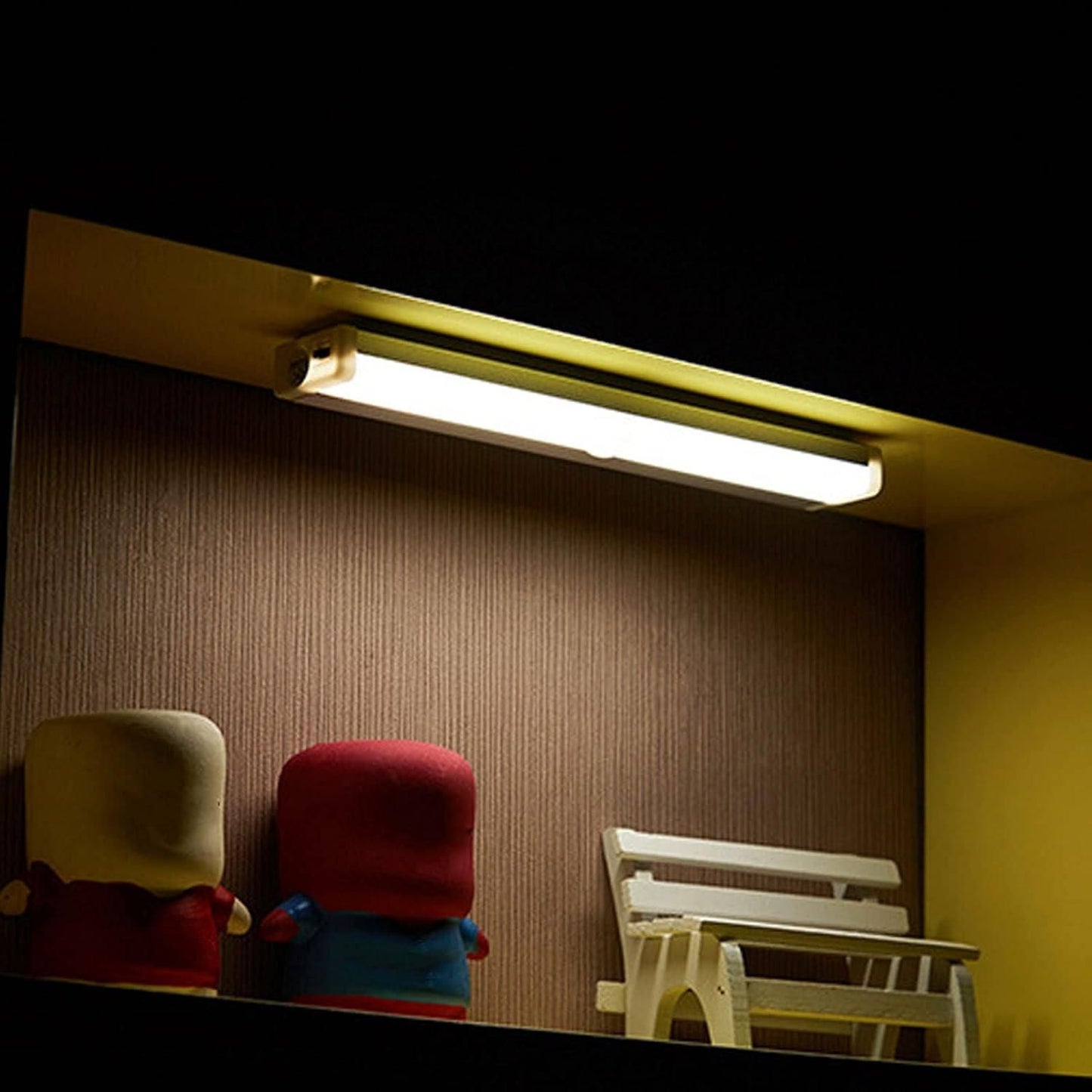 Livingdot USB rechargeable LED light mounted under shelf illuminating decorative items