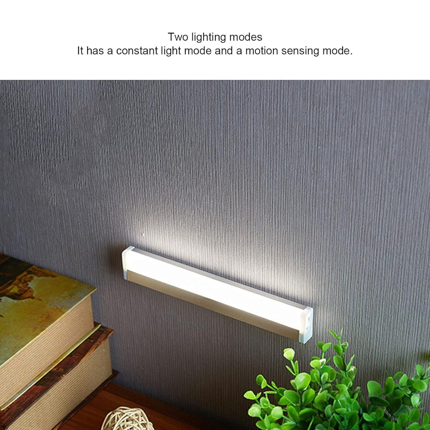 Livingdot USB rechargeable LED light mounted on wall illuminating a desk with books and a plant