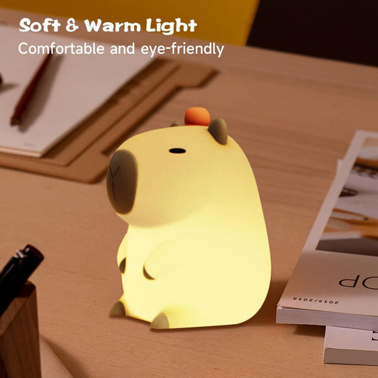 Cute animal-shaped children's night light LED glowing with soft and warm light on wooden desk