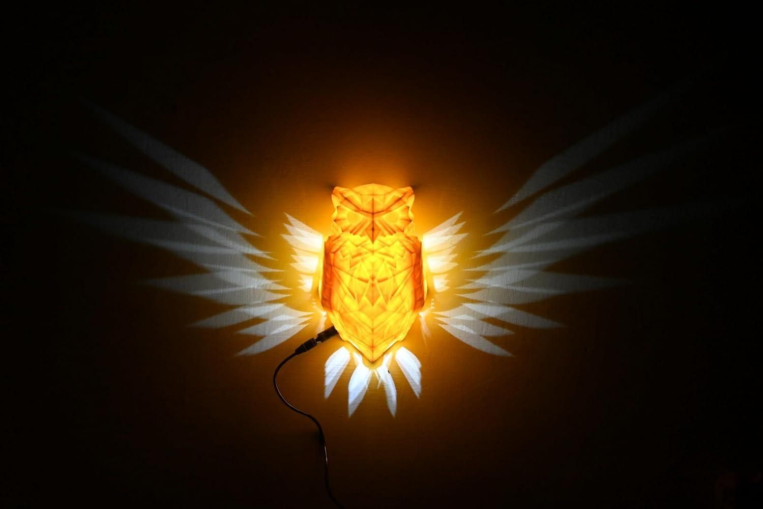Livingdot unique owl wall light glowing orange with white wings projection on dark wall